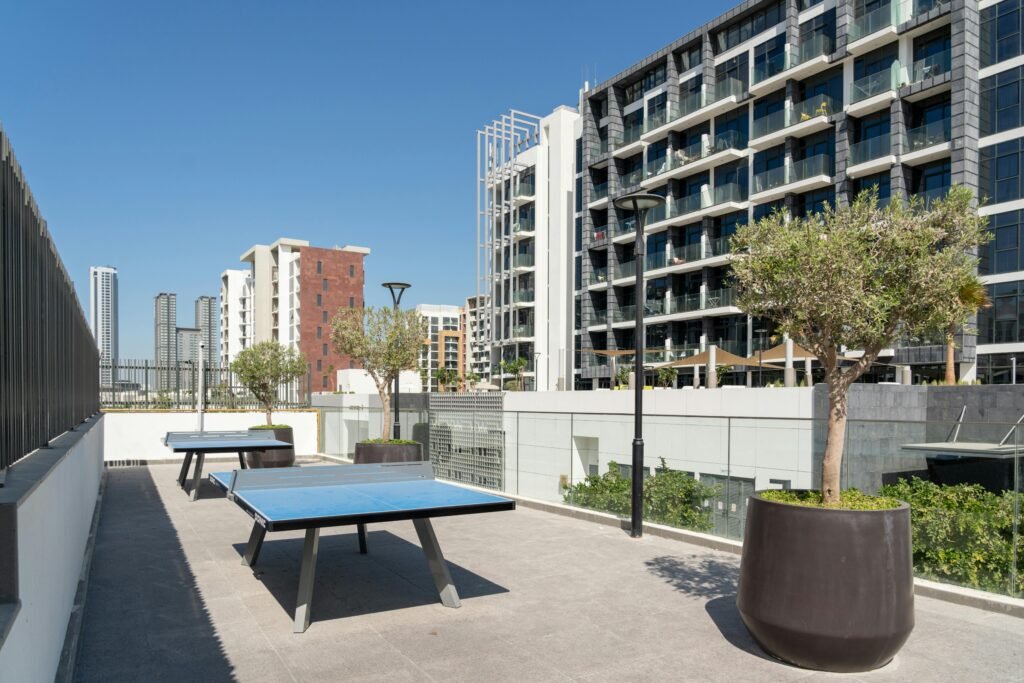 Rooftop terrace in Dubai featuring table tennis tables and modern architecture.